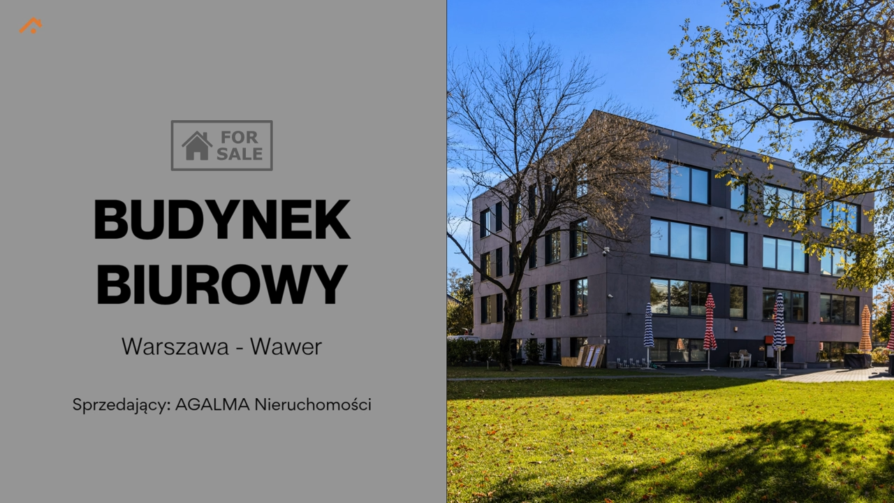 Nowoczesny budynek biurowy w Warszawie, trawnik przed wejściem i napis „BUDYNEK BIUROWY”.